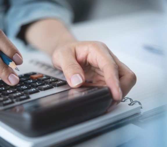 Close,Up,Woman,Hand,Using,Calculator,To,Calculate,Home,Finance