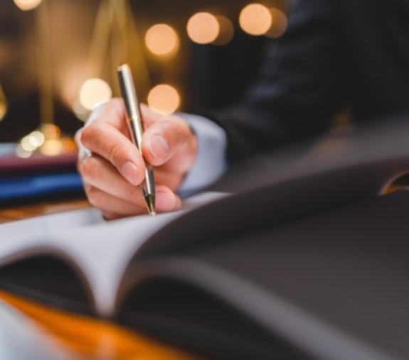 Successful,Businessmen's,Hand,Putting,Signing,Contract,Or,Agreement,Form,,Lawyers